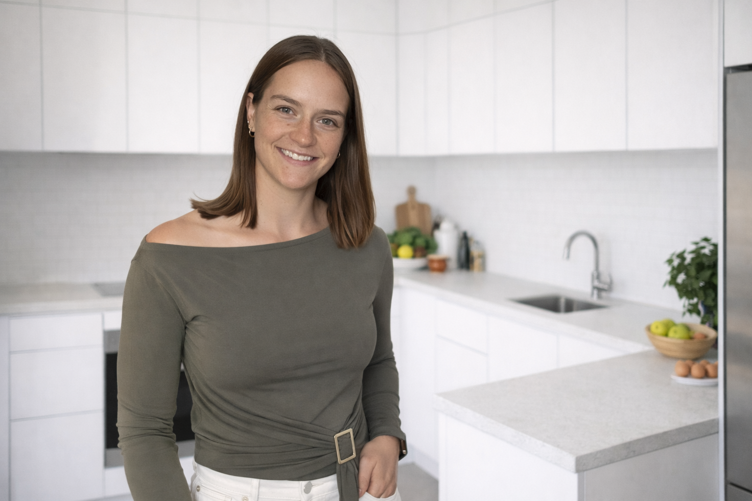 Aleisha Smith wearing a khaki top in a bright kitchen